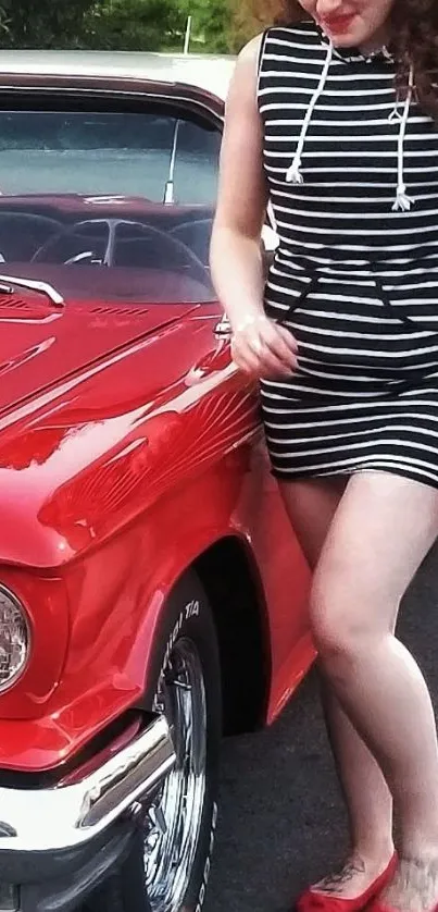 Woman in striped dress with vintage red car.