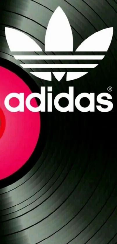 Adidas logo with pink vinyl record on black background.