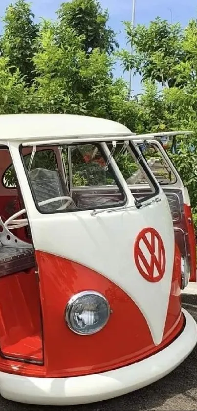 Classic red Volkswagen van with open doors in an outdoor setting.