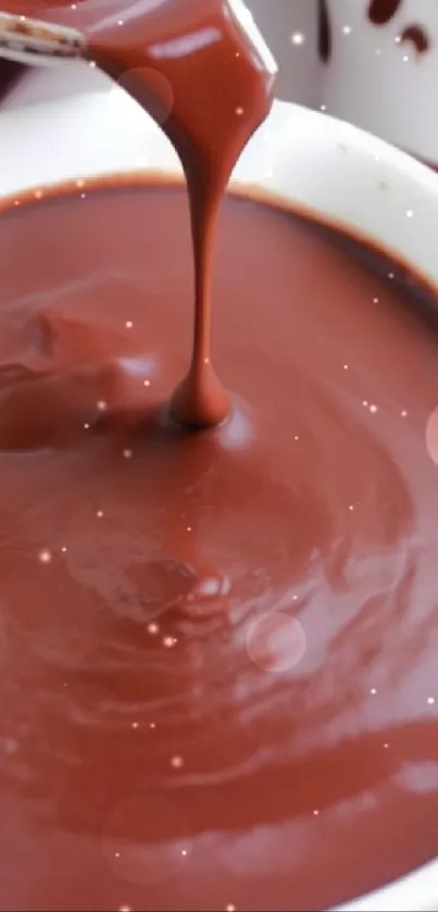 Luxurious and creamy chocolate sauce flowing into a bowl for a rich dessert delight.