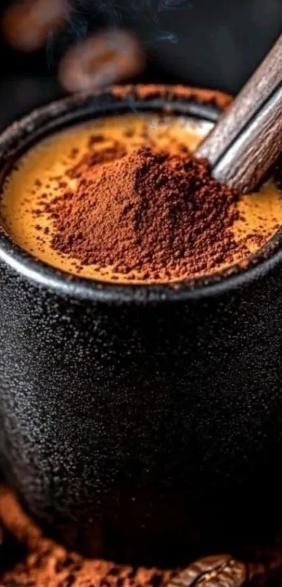 A black mug filled with coffee, topped with cocoa powder, and wooden stirrer.