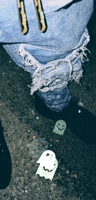 Ripped jeans with ghost stickers on a dark street background.