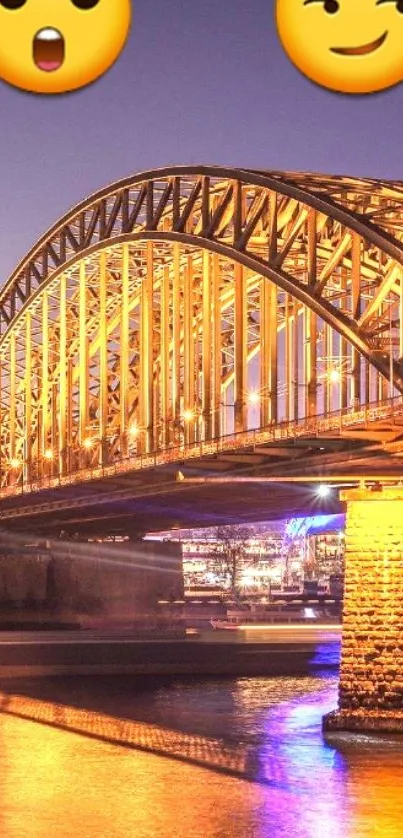 Bridge with golden lights and emojis at night over a reflective river.