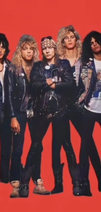 80s rock band in leather jackets on vibrant red backdrop.