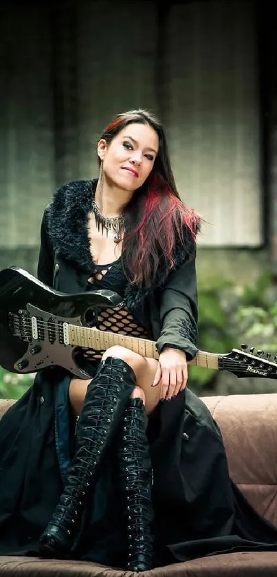 Woman with guitar in black outfit on couch in rustic setting.