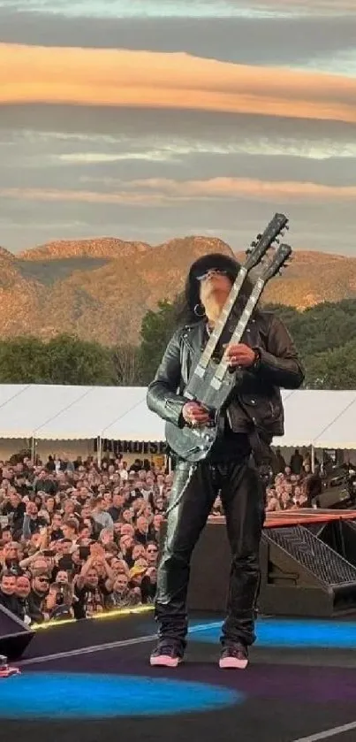 Rock concert with mountainous backdrop and crowd captured at sunset.