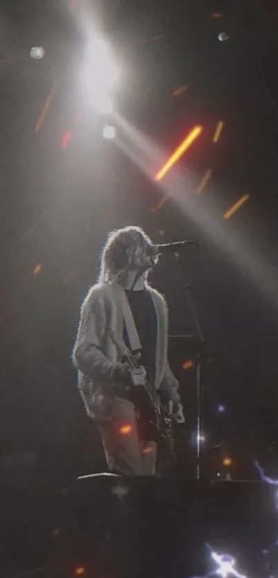 Guitarist under stage lights in black and white concert scene wallpaper.