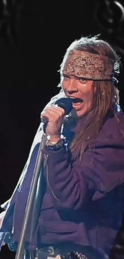 Rock star singing passionately on stage with a microphone, wearing a purple jacket.