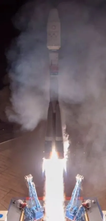 Dynamic nighttime rocket launch with flames and smoke.