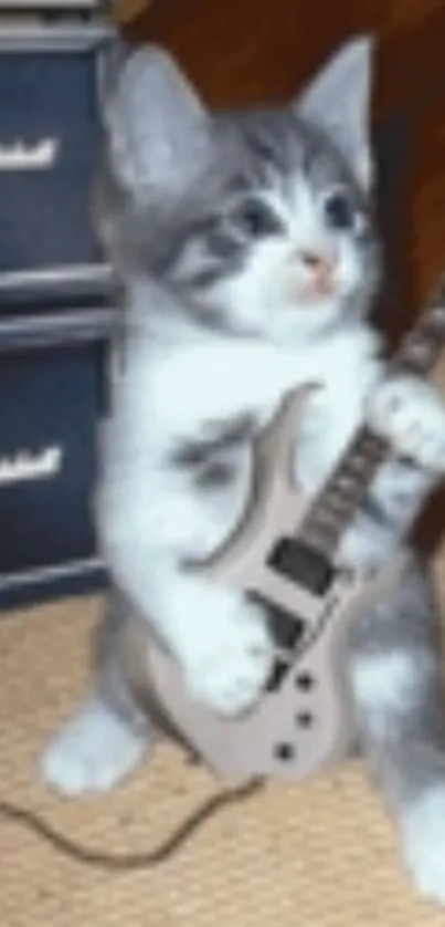 Adorable kitten playing guitar wallpaper.