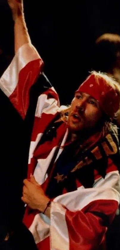 Rockstar passionately performing on stage with bandana and vibrant flag.