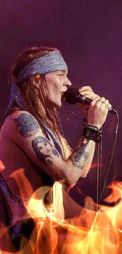 Rockstar singing passionately on stage with tattoos and purple backdrop.