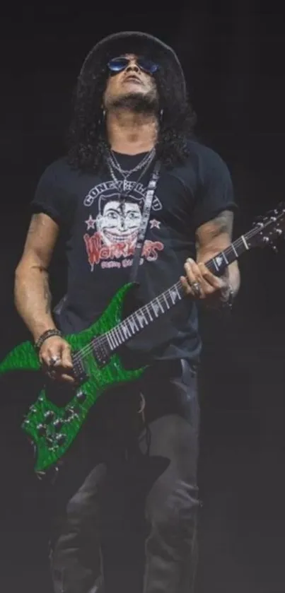 Rockstar playing electric guitar on stage with vibrant green guitar.