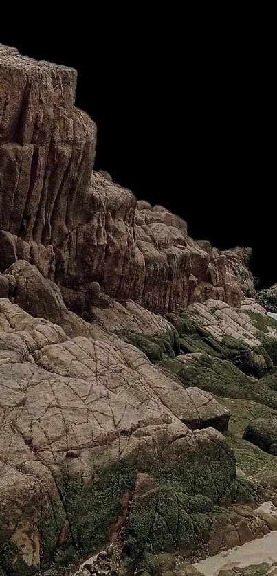 Rugged rocky coastal landscape with cliffs and greenery.