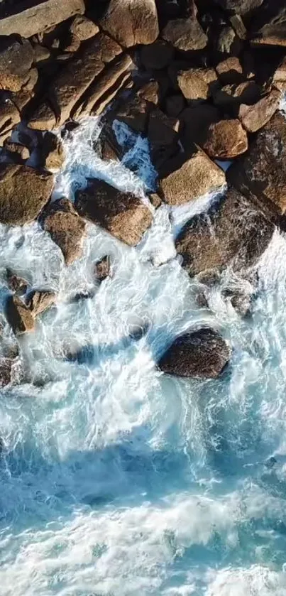 Aerial view of rocky coastline with crashing blue waves.