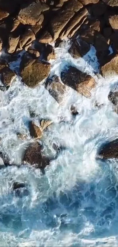 Aerial view of ocean waves crashing against rocky shore.