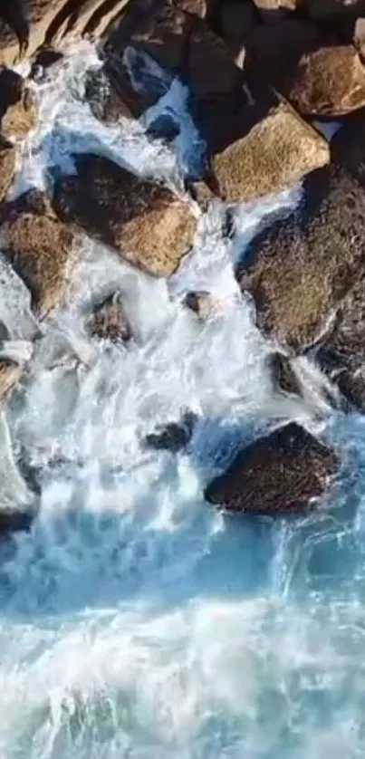 Aerial view of ocean waves crashing against rocky coastline in nature.