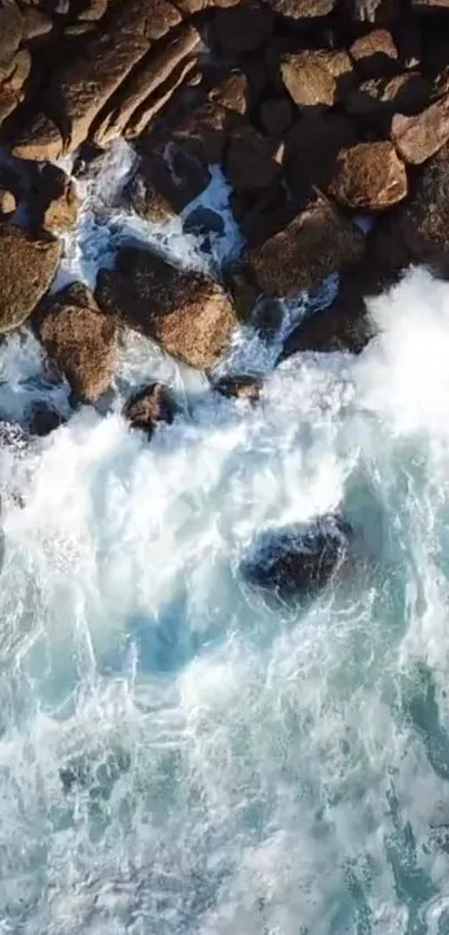 Aerial view of ocean waves crashing over rocky shoreline.