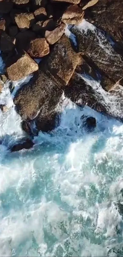 Aerial view of ocean waves crashing on rocky coast.