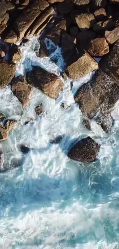 Aerial view of ocean waves crashing against rocky shore.