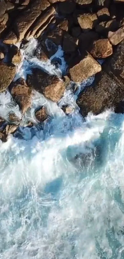 Aerial view of ocean waves crashing on a rocky shore.