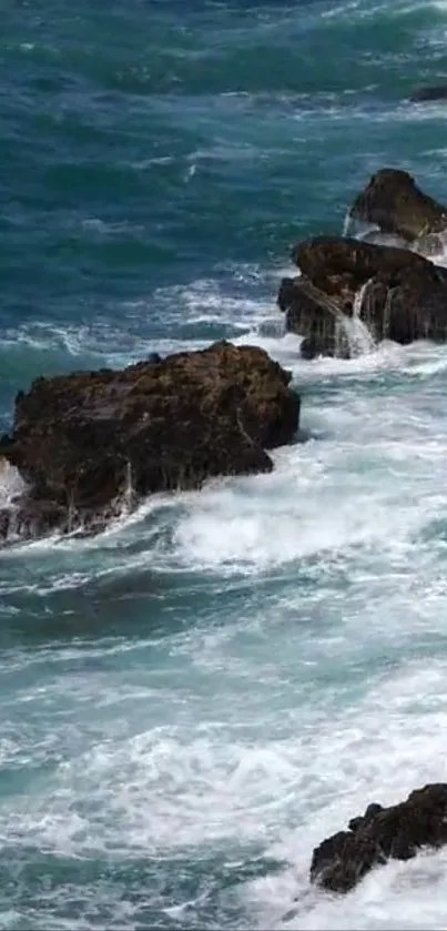 Ocean waves crashing on rocky shore in vibrant teal.