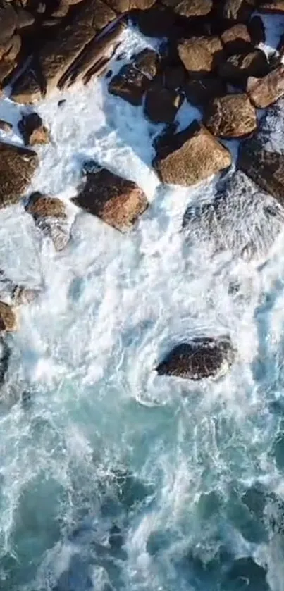 Aerial view of ocean waves crashing onto a rocky shoreline, showcasing nature's power.