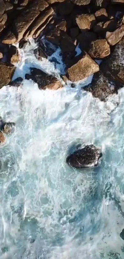 Aerial view of waves crashing on a rocky shoreline, capturing natural beauty.