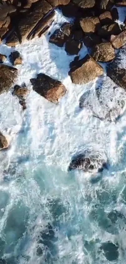 Aerial view of rocky coastline with ocean waves.