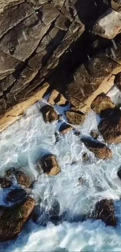 Aerial view of waves crashing on a rocky shoreline.