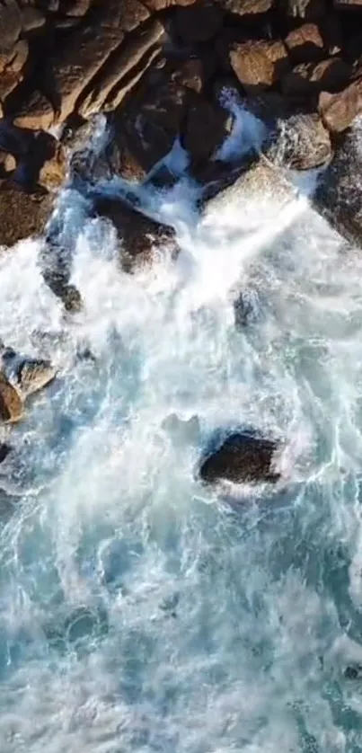 Aerial view of waves crashing against a rocky shoreline.