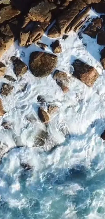 Aerial view of rocky shoreline with waves crashing against the rocks.