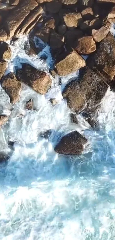 Aerial view of a rocky shoreline with ocean waves.