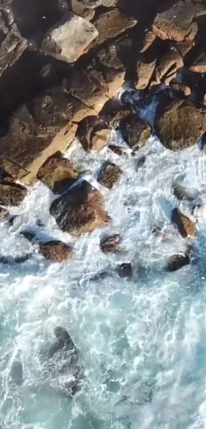 Aerial view of rocky shoreline with crashing ocean waves.