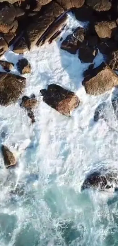 Aerial shot of rocky coastline with waves crashing against the rocks.