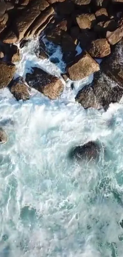 Aerial view of rocky shoreline with blue ocean waves.