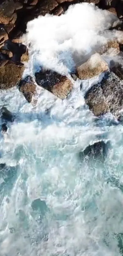 Aerial view of ocean waves crashing over rocky shore.