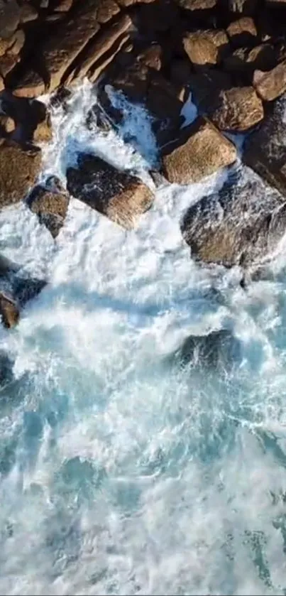 Aerial view of ocean waves crashing on rocky shore.