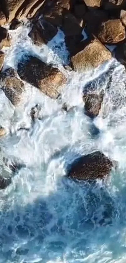 Aerial view of ocean waves crashing on rocky shore.