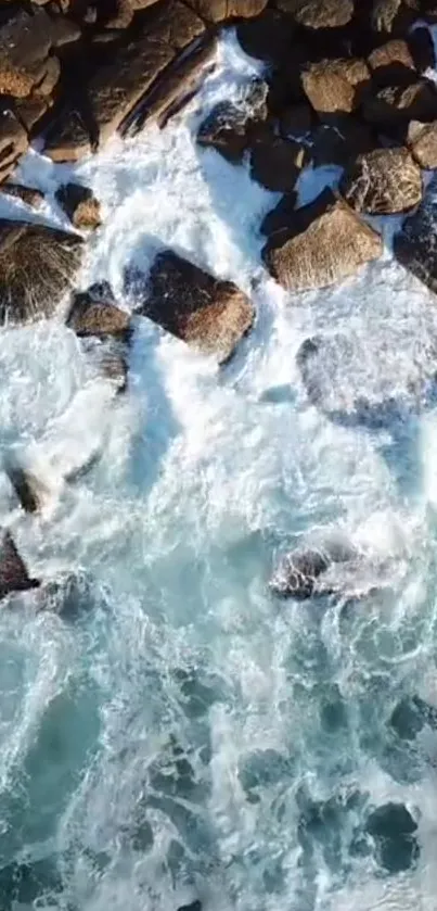 Aerial view of rocky shoreline with ocean waves crashing.