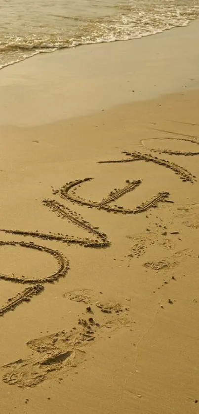 Romantic beach sand message saying 'LOVE YOU' by the ocean.