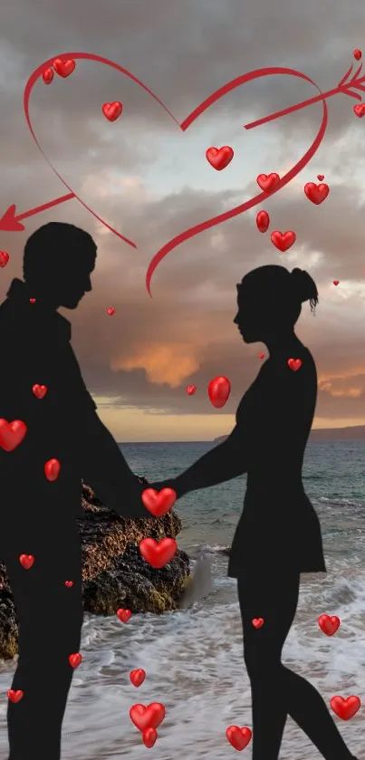 Silhouette couple on beach with hearts in the sky at sunset.