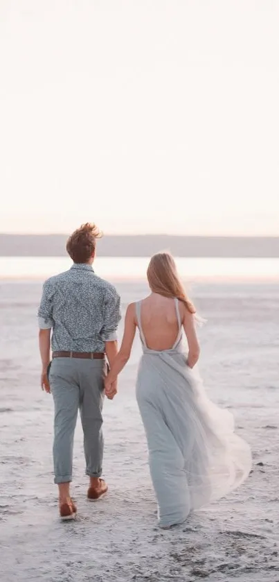 Couple walking on a tranquil beach at sunset, creating a serene and romantic scene.