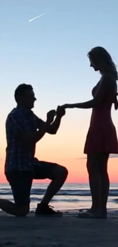 Romantic beach proposal during sunset with a silhouette of a couple.