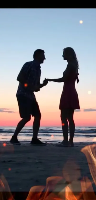 Silhouette of a couple enjoying a vibrant beach sunset.