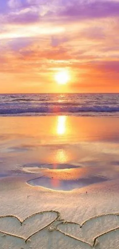 Romantic beach sunset with hearts in sand and vibrant sky.