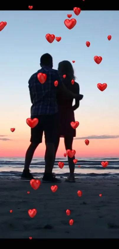 Silhouetted couple on beach at sunset with floating red hearts.