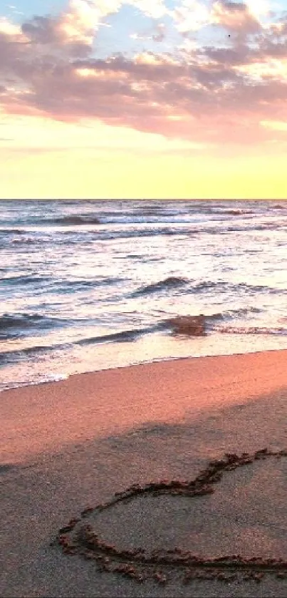 Beach sunset with heart in sand reflecting romantic vibes.