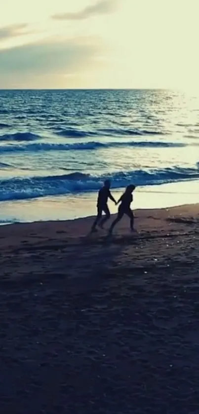 Couple walking on beach at sunset, creating a romantic ocean view wallpaper.