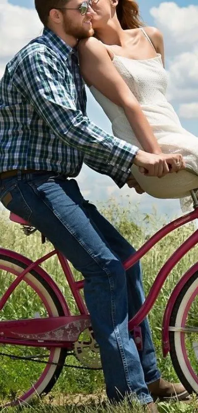 Couple enjoying a romantic bike ride on a pink bicycle in a scenic outdoor setting.